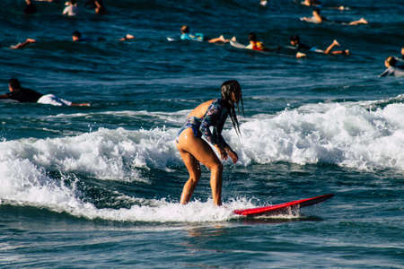 Tel Aviv Israel October 07, 2019 View of unknown Israeli people practicing surfing on Tel Aviv beach in the morningのeditorial素材