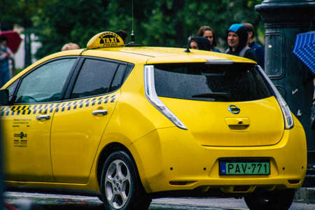 Budapest Hungary july 17, 2020 View of a traditional yellow Hungarian taxi for passengers driving through the streets of Budapest the capital of Hungaryのeditorial素材