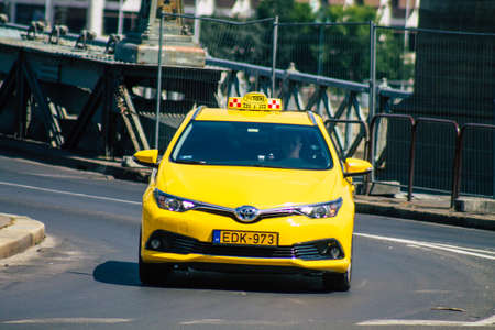 Budapest Hungary july 20, 2020 View of a traditional yellow Hungarian taxi for passengers driving through the streets of Budapest the capital and the most populous city of Hungaryのeditorial素材