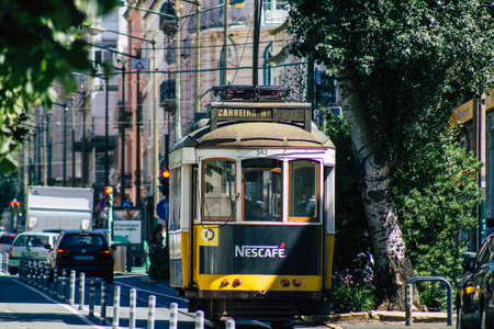 Lisbon Portugal july 24, 2020 View of a traditional old electric tram for passengers driving through the streets and part of the public transport system of Lisbon, the coastal capital city of Portugalの写真素材