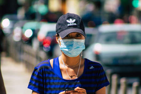 Lisbon Portugal july 24, 2020 View of unidentified pedestrians with a face to protect themself from the coronavirus walking in the historical streets of Lisbon, the coastal capital city of Portugalのeditorial素材
