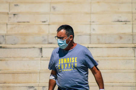 Lisbon Portugal july 24, 2020 View of unidentified pedestrians with a face to protect themself from the coronavirus walking in the historical streets of Lisbon, the coastal capital city of Portugalのeditorial素材