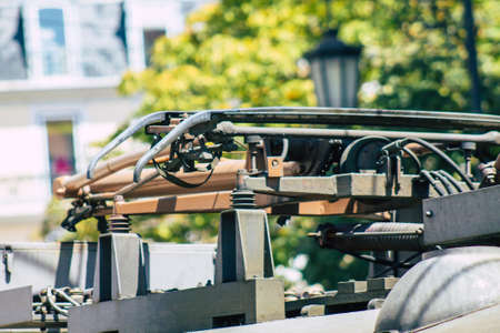 Lisbon Portugal july 26, 2020 View of a traditional old electric tram for passengers driving through the streets and part of the public transport system of Lisbon, the coastal capital city of Portugalの写真素材