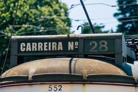 Lisbon Portugal july 26, 2020 View of a traditional old electric tram for passengers driving through the streets and part of the public transport system of Lisbon, the coastal capital city of Portugalの写真素材