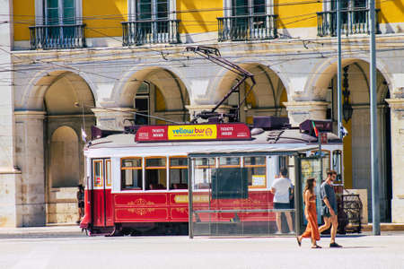 Lisbon Portugal August 01, 2020 View of a traditional old electric tram for passengers driving through the streets and part of the public transport system of Lisbon, the coastal capital city of Portugalの写真素材