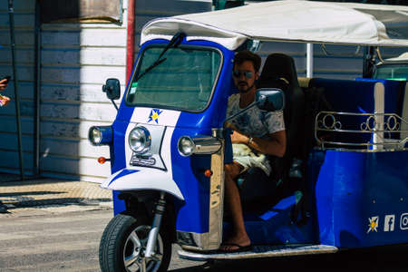 Lisbon Portugal August 01, 2020 View of a tuk tuk for tourists driving through the streets of Lisbon, the hilly coastal capital city of Portugal and one of the oldest cities in Europeのeditorial素材