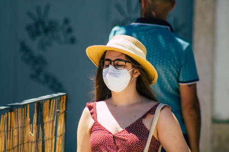 Lisbon Portugal August 01, 2020 View of unidentified pedestrians with a face mask to protect themself from the coronavirus walking in the historical streets of Lisbon, the capital city of Portugalのeditorial素材