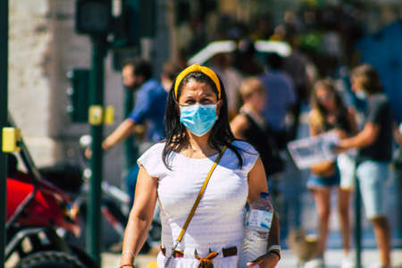 Lisbon Portugal August 01, 2020 View of unidentified pedestrians with a face mask to protect themself from the coronavirus walking in the historical streets of Lisbon, the capital city of Portugalのeditorial素材