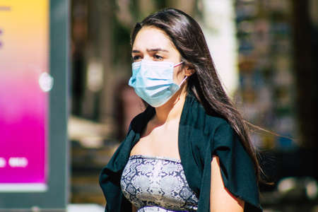 Lisbon Portugal August 01, 2020 View of unidentified pedestrians with a face mask to protect themself from the coronavirus walking in the historical streets of Lisbon, the capital city of Portugalのeditorial素材