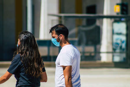 Lisbon Portugal August 01, 2020 View of unidentified pedestrians with a face mask to protect themself from the coronavirus walking in the historical streets of Lisbon, the capital city of Portugalのeditorial素材