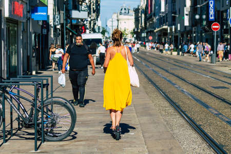 Reims France September 04, 2020 View of unidentified people rolling with an electric scooter in the streets of Reims, operating with a small utility internal combustion engines and a deck in the centerのeditorial素材