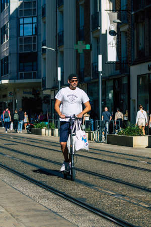 Reims France September 04, 2020 View of unidentified people rolling with an electric scooter in the streets of Reims, operating with a small utility internal combustion engines and a deck in the centerのeditorial素材