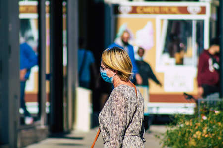 Reims France September 04, 2020 View of unidentified pedestrians with a face mask to protect themself from the coronavirus walking in the streets of Reims, a city in the Grand Est region of Franceのeditorial素材
