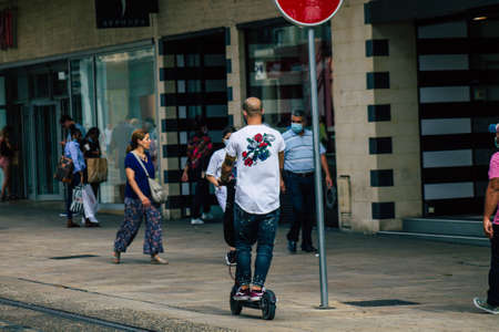 Reims France September 04, 2020 View of unidentified people rolling with an electric scooter in the streets of Reims, operating with a small utility internal combustion engines and a deck in the centerのeditorial素材