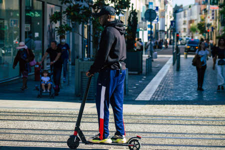 Reims France September 04, 2020 View of unidentified people rolling with an electric scooter in the streets of Reims, operating with a small utility internal combustion engines and a deck in the centerのeditorial素材