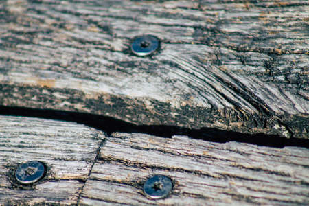 Closeup of a rustic wooden bridge spanning a pond in the french countryside in the fall