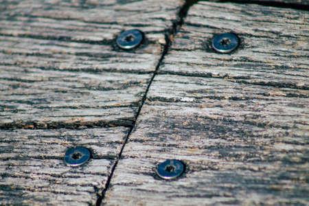Closeup of a rustic wooden bridge spanning a pond in the french countryside in the fallの写真素材