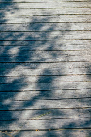 Closeup of a rustic wooden bridge spanning a pond in the french countryside in the fallの写真素材