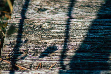 Closeup of a rustic wooden bridge spanning a pond in the french countryside in the fallの写真素材