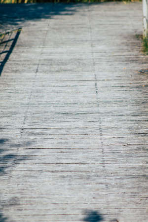 Closeup of a rustic wooden bridge spanning a pond in the french countryside in the fallの写真素材