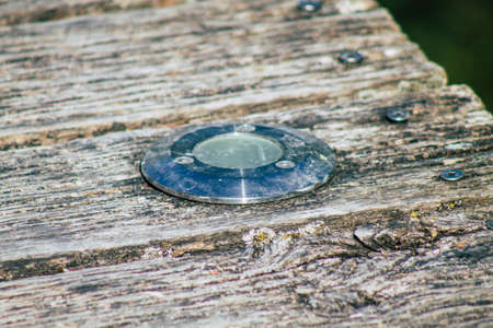 Closeup of a rustic wooden bridge spanning a pond in the french countryside in the fallの写真素材