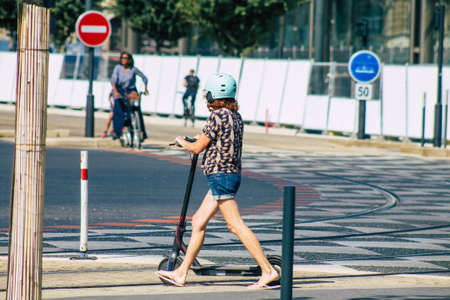 Reims France September 12, 2020 View of unidentified people rolling with an electric scooter in the streets of Reims, operating with a small utility internal combustion engines and a deck in the centerのeditorial素材
