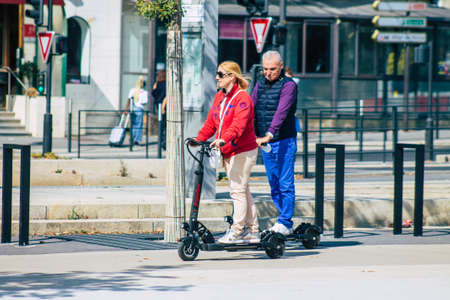 Reims France September 12, 2020 View of unidentified people rolling with an electric scooter in the streets of Reims, operating with a small utility internal combustion engines and a deck in the centerのeditorial素材