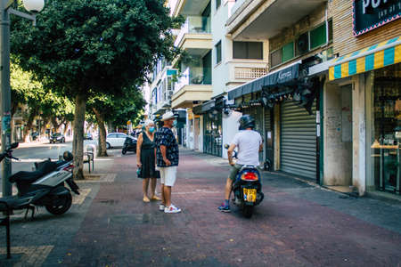 Tel Aviv Israel September 29, 2020 View of unidentified people with a face mask to protect from the Coronavirus walking in the empty streets of Tel Aviv during lockdown and Coronavirus outbreakのeditorial素材