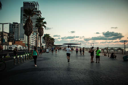 Tel Aviv Israel October 04, 2020 View of unidentified people without a face mask to protect themself walking on Herbert Samuel Promenade in Tel Aviv during lockdown and Coronavirus outbreakのeditorial素材