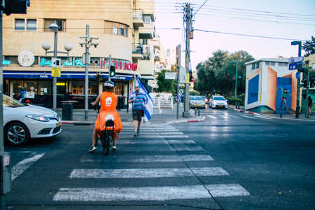 Tel Aviv Israel October 10, 2020 View of an unidentified people with a face mask to protect from the Coronavirus rolling in the empty streets of Tel Aviv during lockdown and Coronavirus outbreakのeditorial素材