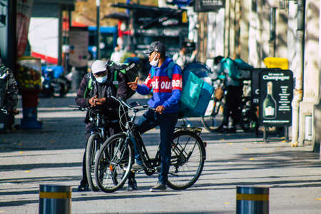 Reims France October 31, 2020 View of food home delivery people working in downtown during the...