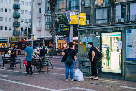 Tel Aviv Israel October 27, 2020 View of an unidentified person with a face mask to protect themselves from the Coronavirus waiting at a bus stop during the lockdown and the Coronavirus outbreakのeditorial素材