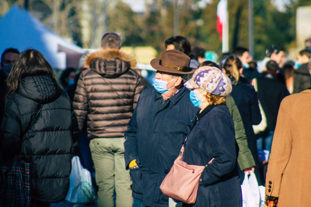 Reims France January 09, 2021 View of unidentified people with a face mask shopping at the market in downtown during Coronavirus outbreak and lockdown to enforce containment of the populationのeditorial素材