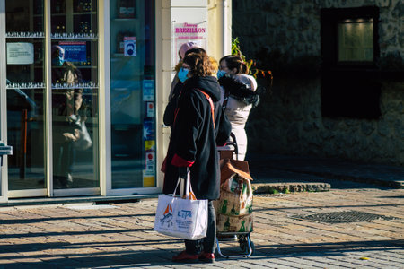 Reims France January 09, 2021 View of unidentified people with a face mask shopping at the market in downtown during Coronavirus outbreak and lockdown to enforce containment of the populationのeditorial素材