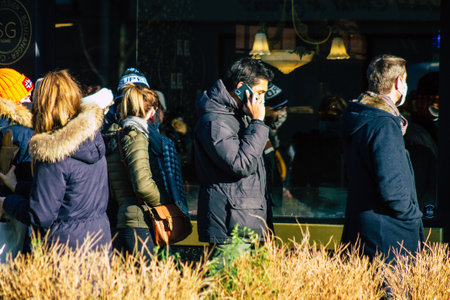 Reims France January 09, 2021 View of unidentified people with a face mask shopping at the market in downtown during Coronavirus outbreak and lockdown to enforce containment of the populationのeditorial素材