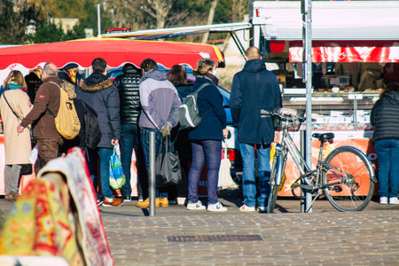 Reims France January 09, 2021 View of unidentified people with a face mask shopping at the market in downtown during Coronavirus outbreak and lockdown to enforce containment of the populationのeditorial素材