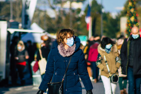 Reims France January 09, 2021 View of unidentified people with a face mask shopping at the market in downtown during Coronavirus outbreak and lockdown to enforce containment of the populationのeditorial素材
