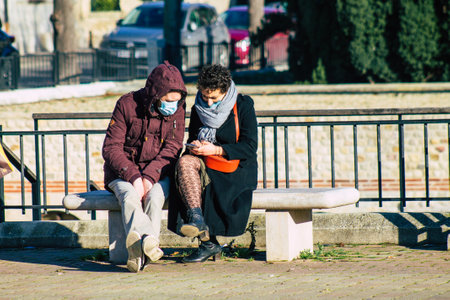 Reims France January 09, 2021 View of unidentified french people sitting in the streets of Reims to take a lunch because all the restaurants closed during the pandemic affecting Franceのeditorial素材
