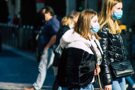 Reims France February 27, 2021 Unidentified pedestrians with a face mask to protect themself from the coronavirus walking in the streets of Reims during the pandemic affecting Franceのeditorial素材