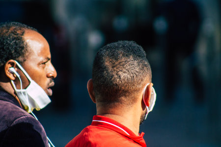 Reims France February 27, 2021 Unidentified pedestrians with a face mask to protect themself from the coronavirus walking in the streets of Reims during the pandemic affecting Franceのeditorial素材