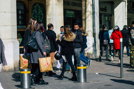 Reims France February 27, 2021 Unidentified pedestrians with a face mask to protect themself from the coronavirus walking in the streets of Reims during the pandemic affecting Franceのeditorial素材