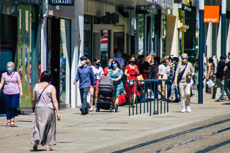 Reims France June 11, 2021 Pedestrians walking in the streets of Reims during the coronavirus outbreak hitting France, wearing a mask in the street is mandatoryのeditorial素材