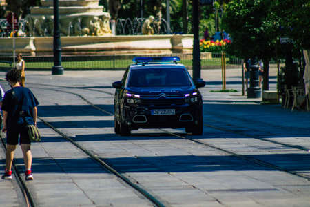Seville Spain July 01, 2021 Police car rolling in the streets of Seville, an emblematic city and the capital of the region of Andalusia, in the south of Spainの写真素材