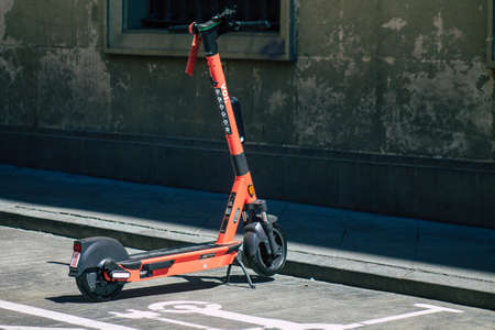 Seville Spain July 01, 2021 Electric scooter to rent parked in the streets of Seville, operating with a small utility internal combustion engines and a deck in the centerの写真素材