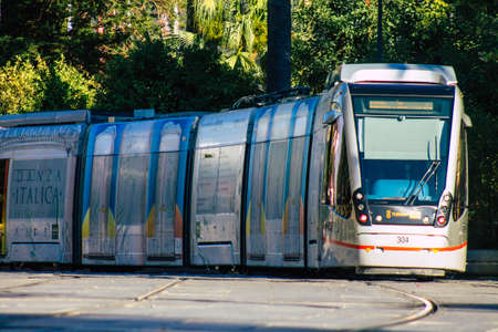 Seville Spain July 01, 2021 Modern electric tram for passengers rolling through the streets of Seville, an emblematic city and the capital of the region of Andalusia, in the south of Spainの写真素材