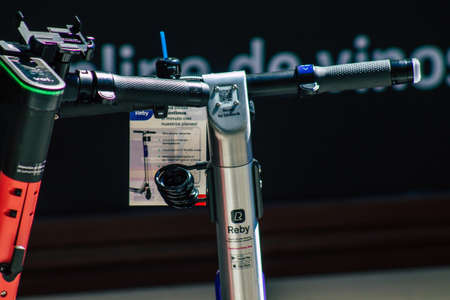 Seville Spain July 02, 2021 Electric scooter to rent parked in the streets of Seville, operating with a small utility internal combustion engines and a deck in the centerの写真素材