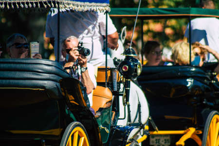 Seville Spain July 03, 2021 Horse drawn carriage ride through Seville. Travel through the historic center of Seville and during the carriage ride people will be able to contemplate the main monumentsの写真素材