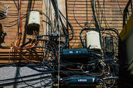 Seville Spain July 03, 2021 Electric cables on the facade of a building in the streets of Seville, an emblematic city and the capital of the region of Andalusia, in the south of Spainの写真素材