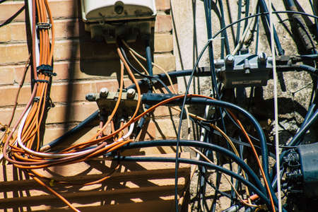 Seville Spain July 03, 2021 Electric cables on the facade of a building in the streets of Seville,...