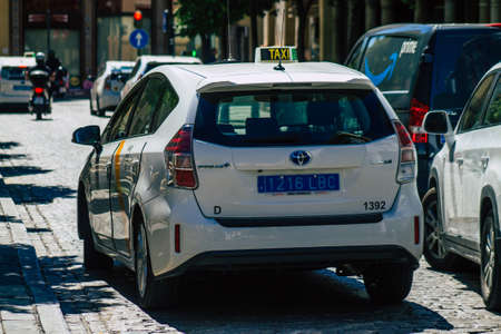 Seville Spain July 01, 2021 Taxi driving through the streets of Seville, an emblematic city and the capital of the region of Andalusia, in the south of Spainのeditorial素材